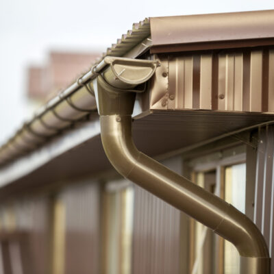 Close up detail of cottage house corner with metal planks siding