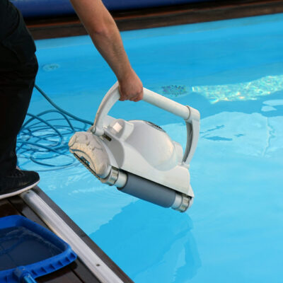 Hotel staff worker cleaning the pool